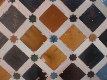 Mosaic of coloured tiles separated by white bands with small stars