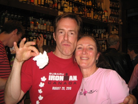 Patrick and Diane standing in tapas bar with Patrick preparing to drop a white napkin on the floor