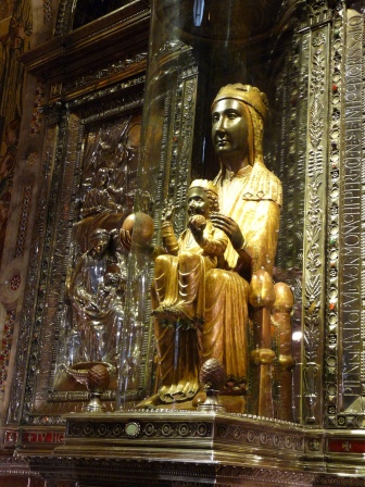 Black madonna in with gold clothing, seated with child on her lap