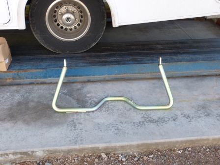 A bent metal bar lying on the ground in front of our RV