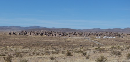 A desert with rocks in the distance